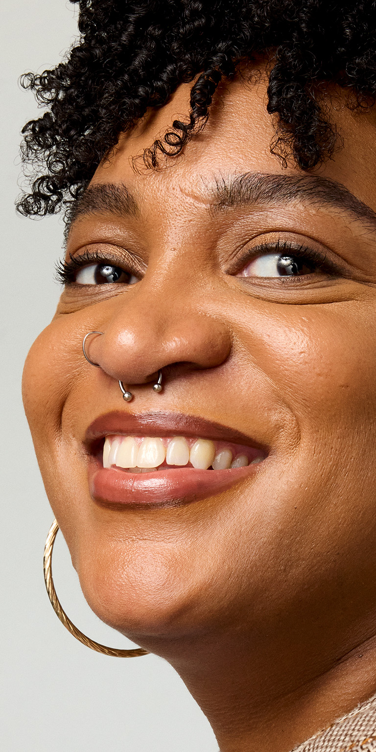 A close up of a woman with cleanser.
